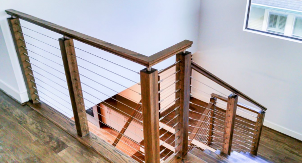 Tangga kayu dengan railing kawat yang kontemporer